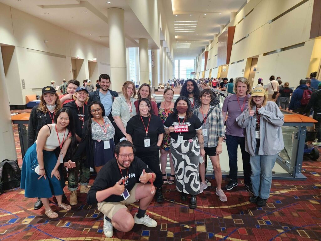 16 of the DSA SF delegates to the DSA National Convention pose together for a group photo at the convention center.