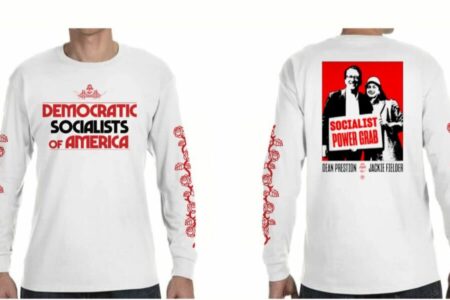 A photo showing a white long-sleeved t-shirt design from the front and the back. The front of the t-shirt has the DSA SF logo above red and black text that says "Democratic Socialists of America." There are red rose designs going up both of the sleeves. The back of the shirt has a picture of Dean Preston and Jackie FIelder in black, red, and white with a sign that says "SOCIALIST POWER GRAB." Below the image is text that says "Dean Preston" and "Jackie Fielder" with the DSA SF logo between their names.